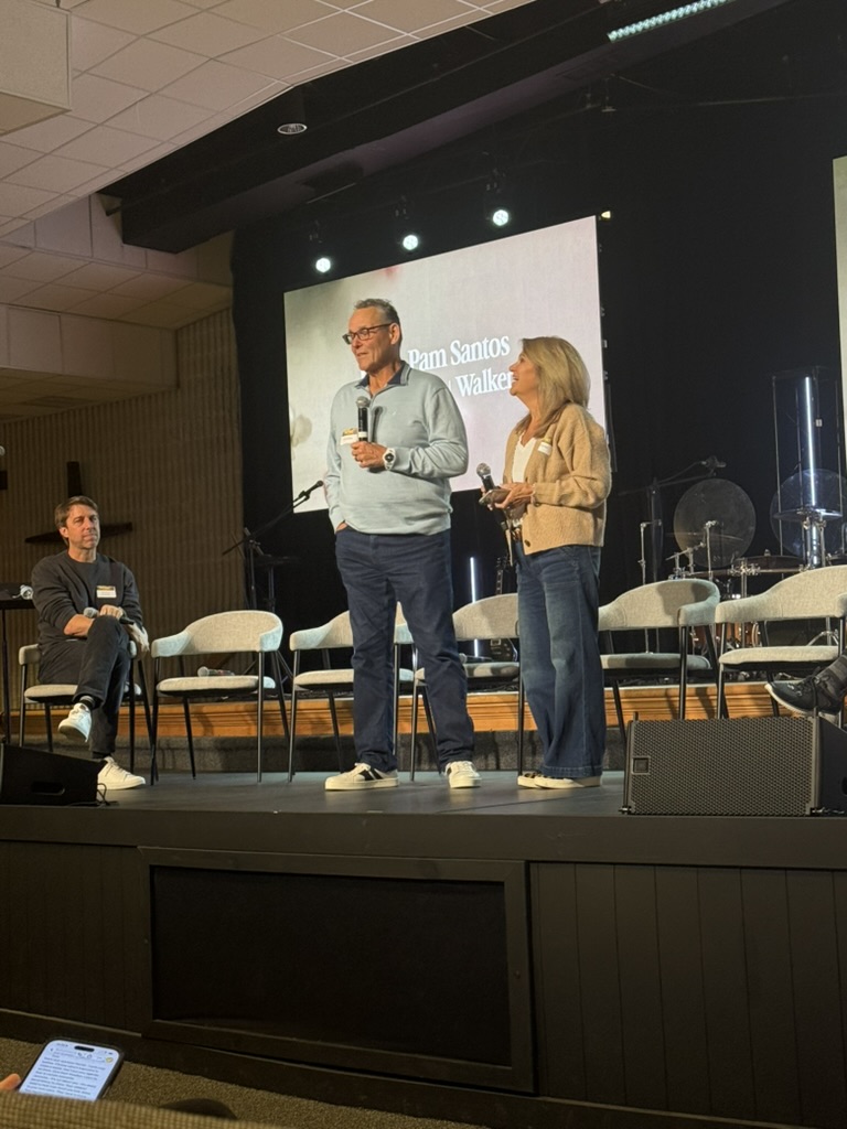 Hal and Pamela Santos speaking on stage
